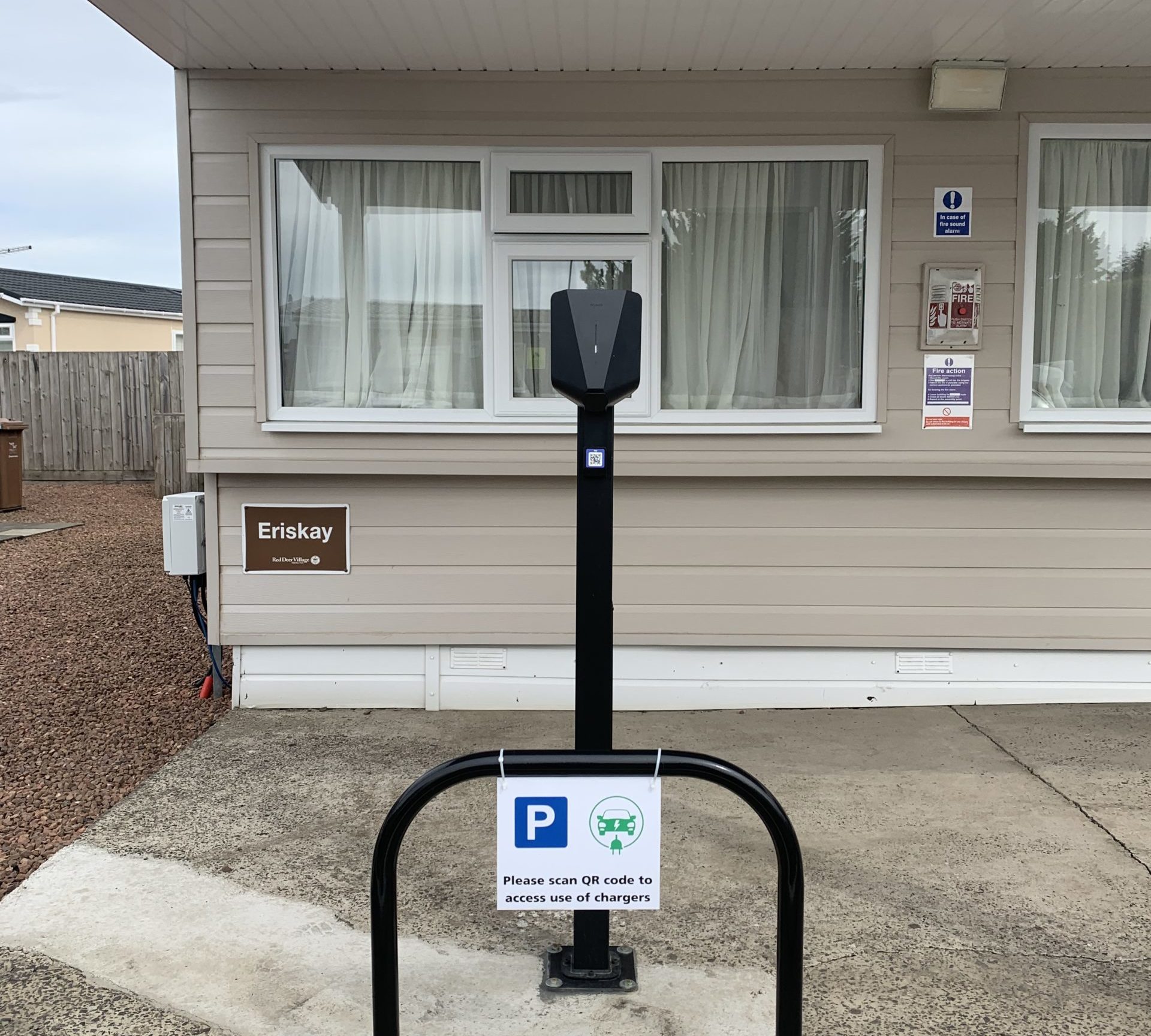 Electric vehicle charging point in red deer village